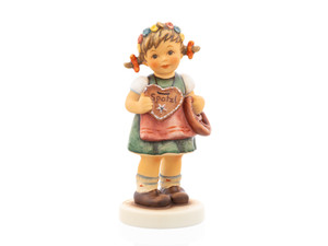 M.I. Hummel figurine HUM 2446 You Belong to Me featuring a girl in a Bavarian dress with a flower wreath, holding a gingerbread heart and a pretzel