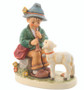 Limited edition M.I. Hummel 'Flute Song' figurine (HUM 407) showing a shepherd boy playing a flute for a white lamb.