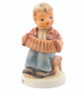 M.I. Hummel 'Accordion Ballad' figurine HUM 857 featuring a boy playing a large accordion while sitting on a stool.

Close-up of the hand-painted bellows and keys of the accordion on the Accordion Ballad figurine.
