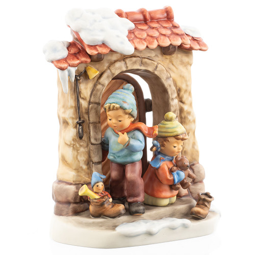 M.I. Hummel figurine St. Nikolas was Here HUM 2012, featuring two children in winter clothes at a snow-covered door with Christmas gifts.