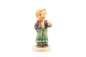 M.I. Hummel figurine HUM 2077/B "A Flower for You" featuring a dapper boy holding a single white blossom.