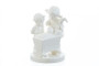 Blessed Event HUM 333 M.I. Hummel White Edition figurine of siblings looking at a newborn in a cradle. Close-up of the intricate porcelain sculpting on the cradle from the M.I. Hummel Blessed Event White figurine.