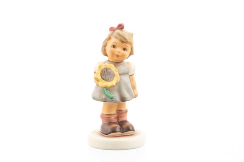 M.I. Hummel Sunflower Girl HUM 2195 porcelain figurine of a young girl in a dress with a yellow sunflower.