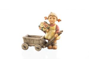 Surprise Visit HUM 2013 M.I. Hummel figurine of a girl in a yellow dress with a flower wagon.