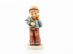 M.I. Hummel Benjamin HUM 2453 Club Year 49 exclusive figurine of a young boy with a songbird on his arm.