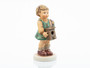 M.I. Hummel Luisa HUM 2454 Club Exclusive figurine of a young girl holding a freshly painted birdhouse.