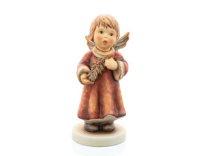 2025 M.I. Hummel Annual Angel figurine HUM 2455, featuring a serene angel in a rustic red robe holding an olive branch, a symbol of peace.