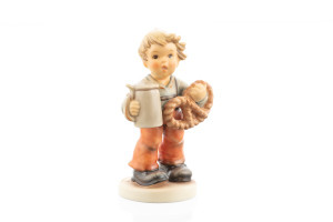 M.I. Hummel Pretzel Boy HUM 2003 porcelain figurine of a young boy holding a pretzel and a beer stein.