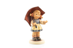 Authentic M.I. Hummel figurine Hope for Tomorrow HUM 2294 showing a girl in a Bavarian dress stretching her hand out from under a red umbrella.