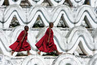 Mingun, Myanmar: Two novice Buddhist monks hurry along one of the seven terraces of the Hsinbyume Pagoda in Mingun, northwest of Mandalay—much as young boys likely have walked or run here for more than 200 years. Built in 1816, the pagoda consists of seven concentric ascending rings around a central stupa, representing the seven mountain ranges that surround Mount Meru, the sacred mountain at the center of the universe in Buddhist cosmology.

Photo © 2011 Charles O. Cecil