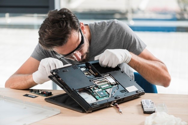 repair tech working on computer