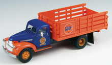 Blue cab with orange fenders and orange stake bed. Gulf Oil logo on the door of the cab.
