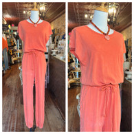 Mineral washed, short sleeve jumpsuit w waist tie and side pockets in tangerine