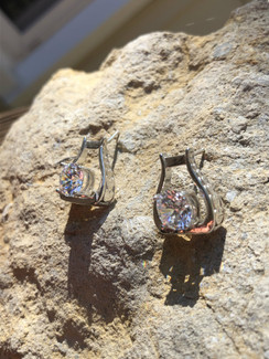 Western Stirrup Earrings. Extra bling is allowed in a western class. 8mm cubic zirconium is placed in the middle of the stirrup and secured to the ear with a post. The detail of hearts cascade along the sides of the western stirrup.  Available with any gemstone and either gold or silver.