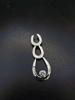 Cascade of horseshoe necklace. 2 smaller horseshoes cascade down to a show shoe with a 4 mm cubic zirconium. This is made with a chain and please specify your length of the chain. Available in gold with any gemstone.  I can customize this piece anyway you desire.