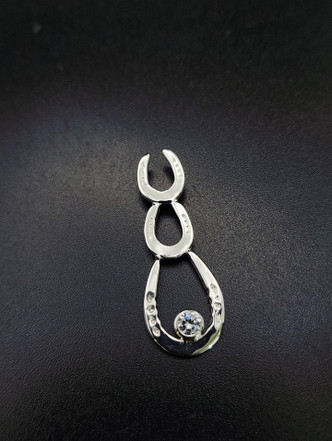 Cascade of horseshoe necklace. 2 smaller horseshoes cascade down to a show shoe with a 4 mm cubic zirconium. This is made with a chain and please specify your length of the chain. Available in gold with any gemstone.  I can customize this piece anyway you desire.