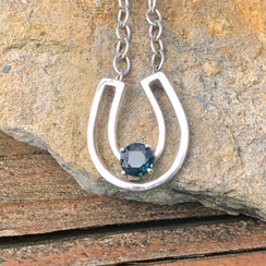  Negative space horseshoe in sterling silver with Sapphire