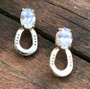 14k gold horseshoe earrings with 6x8 cz or a blue topaz or amethyst with small horseshoe. These are secured to the ear with a post. These are available in sterling silver with any gemstone. Available in gold with any gemstone. Available in sterling silver also call 8593330458.