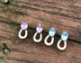 14k gold horseshoe earrings with 6x8 cz or a blue topaz or amethyst with small horseshoe. These are secured to the ear with a post. These are available in sterling silver with any gemstone. Available in gold with any gemstone. Available in sterling silver also call 8593330458.
