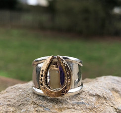 fun Hammered horseshoe ring in 14K gold and sterling silver. Price is based on a size 7 and will cost more to size. It is a very beautiful addition to your equestrian jewelry box and is very bold.