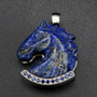 A Lapis carved horse head pendant that is paved with lab sapphires in the lower border to emphasis the blue in the stone. It is a very elegant piece set into geometric patterned sterling silver. This is a truly a very elegant piece with iron pyrite shimmering into the lapis.