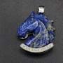 A Lapis carved horse head pendant that is paved with lab sapphires in the lower border to emphasis the blue in the stone. It is a very elegant piece set into geometric patterned sterling silver. This is a truly a very elegant piece with iron pyrite shimmering into the lapis.