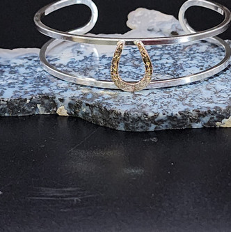 A beautiful sterling silver cuff with a 14k gold horseshoe. This shoe comes either smooth or hammered. I love the play between silver and gold.