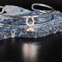 A dainty sterling silver bracelet featuring a small 14k gold horseshoe. A fun play between silver and gold.