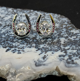 These earrings are sterling silver show or toe horseshoe earrings. They have a Cubic zirconium in the middle and cz in the nail holes. These may be ordered in any combination. The price starts at 270.00 depending on combination of stones and metals. Call 8593330458y metal with any stone.
