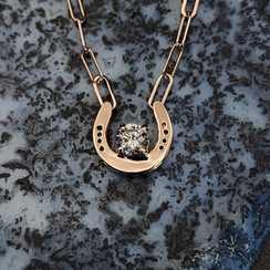 14k rose gold necklace with  horseshoe and cz.