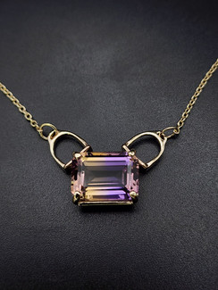 A beautiful ametrine set in 14k gold with stirrup bails. The chains 18 inches long and is a 1.5 cable chain. This is a AAA stone.