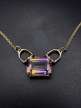 A beautiful ametrine set in 14k gold with stirrup bails. The chains 18 inches long and is a 1.5 cable chain. This is a AAA stone.