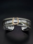 A 14k gold horseshoe soldiered on a sterling silver cuff bracelet. The cuff features a roping detail on the edge. Can be customized. 8593330458