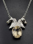 A oval citrine featuring sterling silver horse heads on a 18-inch sterling silver chain necklace!