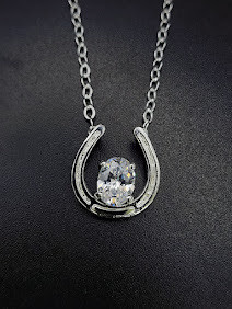 A Sterling silver horseshoe necklace is a classic for an equine fashion look. This comes with an 18-inch chain. Please call 8593330458 to customize.