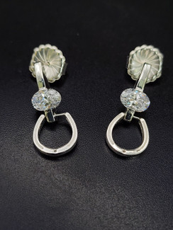 Lightweight horseshoe door knocker earrings that dangle from a post. Featuring a cz. Very stylish!!