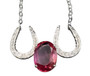 A pink sapphire nestled between 2 sterling silver horseshoes featured in a necklace. Chain is 18 inches. If you wish to make length different call 8593330458
