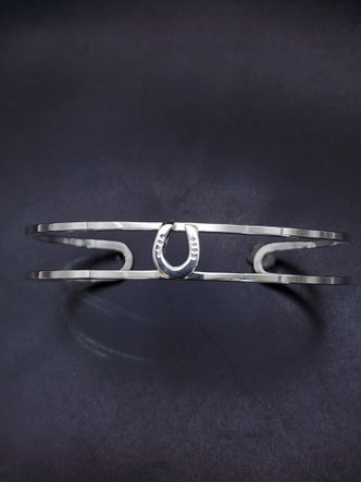 A delicate addition to your wardrobe to fit your equestrian style. A Sterling silver cuff featuring a sterling silver horse shoe!