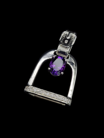 An English stirrup pendant featuring cz and amethyst in the middle for extra bling. The leather strap leather makes a nice bail! Cubic zirconium outlining the bottom of the iron.