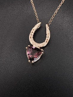 A special 14k rose gold hammered horseshoe featuring a lovely pink tourmaline necklace. The chain is 18 inches. This makes a lovely gift.