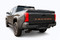 Rear tailgate of black Toyota Tacoma truck showing orange letter and text decals.