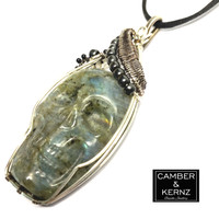 Side view of carved labradorite skull Accented with hematite and black agates