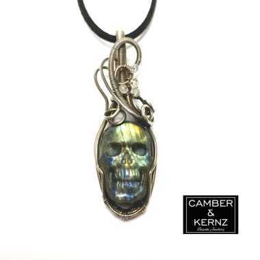 Front view of carved Labradorite skull pendant wrapped in oxidized Silver Plate wire