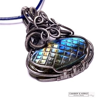 Oval carved labradorite pendant wrapped in oxidised silver plate wire 