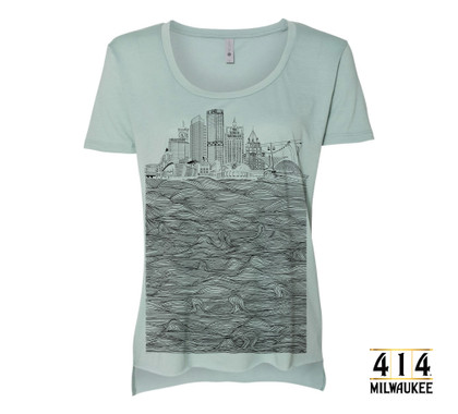 Mint green Milwaukee skyline t-shirt featuring US Bank, NM Tower, Fiserv Forum, UW-Milwaukee Panther Arena, Mitchel Park Domes, Milwaukee Art Museum, 100 East Building, Milwaukee Center, Gas Light Building, Quarels and Brady tower, Rockwell, Allen Bradley, Polish Moon, and Discovery World. Tri-blend shirt vintage soft unisex t-shirt.  3.5 oz., 65% Poly/ 35% Combed Ring-Spun Cotton, 40 single. 1x1 baby rib. Hemmed sleeve. Side seamed. Raw edge, exaggerated tail drop hem.