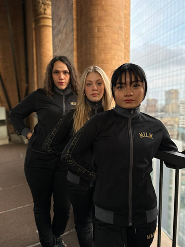 414 Black and Gold Track Womens. Gold embroidery. 414 arm length tape. Slim fit. Full zip with ribbed stand-up collar. 52% cotton, 48% recycled polyester doubleknit. Front zip pockets