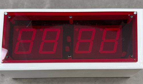 Close up view of clock in case with red shield