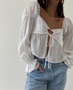 MaliBoHo White TIE FRONT BLOUSE TOP  80%RAYON, 20%NYLON l LINING: 100%POLYESTER .MODEL IS 5'7" AND IS WEARING A SMALL.