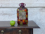 A CHARMING ANTIQUE STAINED GLASS EFFECT DEMIJOHN BOTTLE