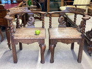 A FINE PAIR OF ANTIQUE CARVED OAK HALL OR CONVERSATION CHAIRS